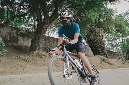 Asian man riding a bike.