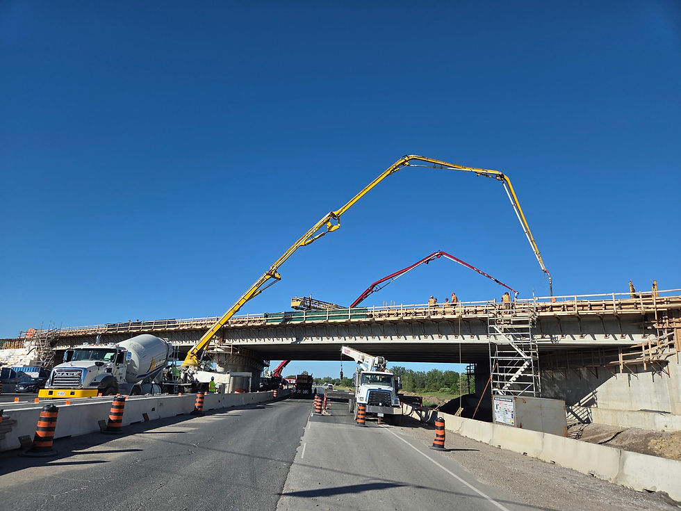 Concrete pump truck working on a highway bridge project