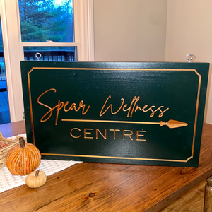 Custom branded wooden sign for a business.