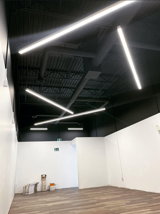 Empty modern room with black ceiling and linear LED lights