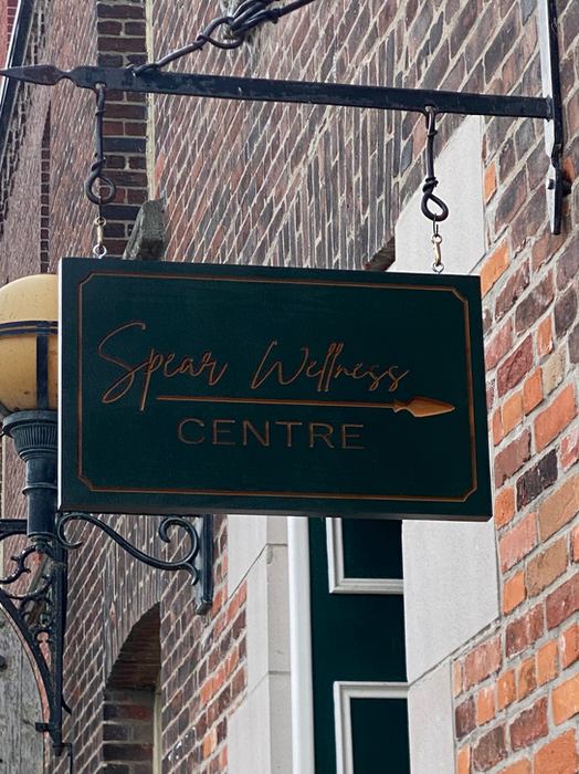 Custom branded wooden sign for a business.