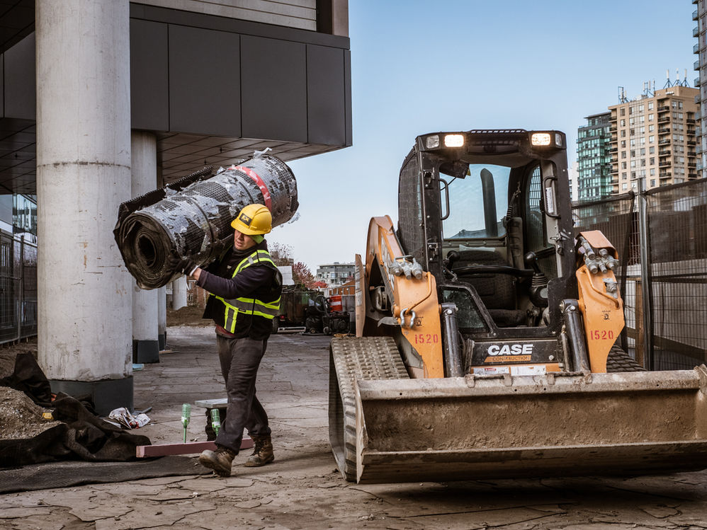 construction worker carrying materials
