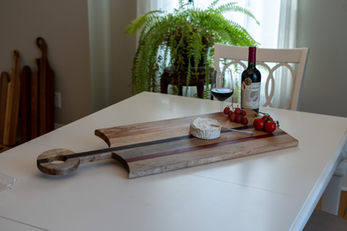 Multi toned charcuterie board with long handle