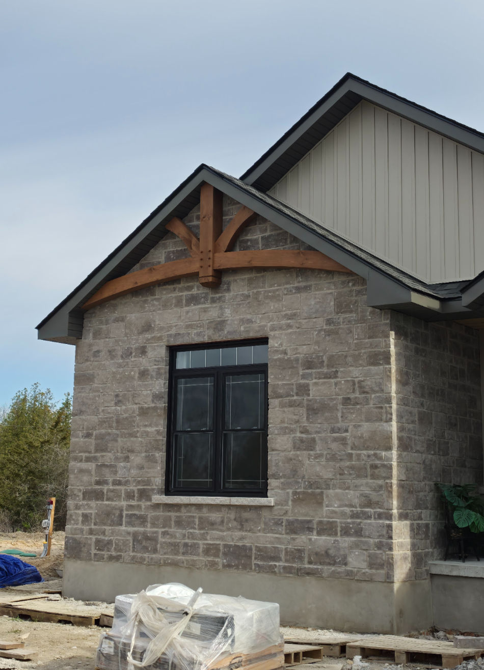 Stone house exterior with decorative wood gable truss