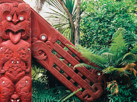 Māori carving on a meeting house, symbolising ancestral presence, spiritual protection, and sacred boundaries in wairua practice.