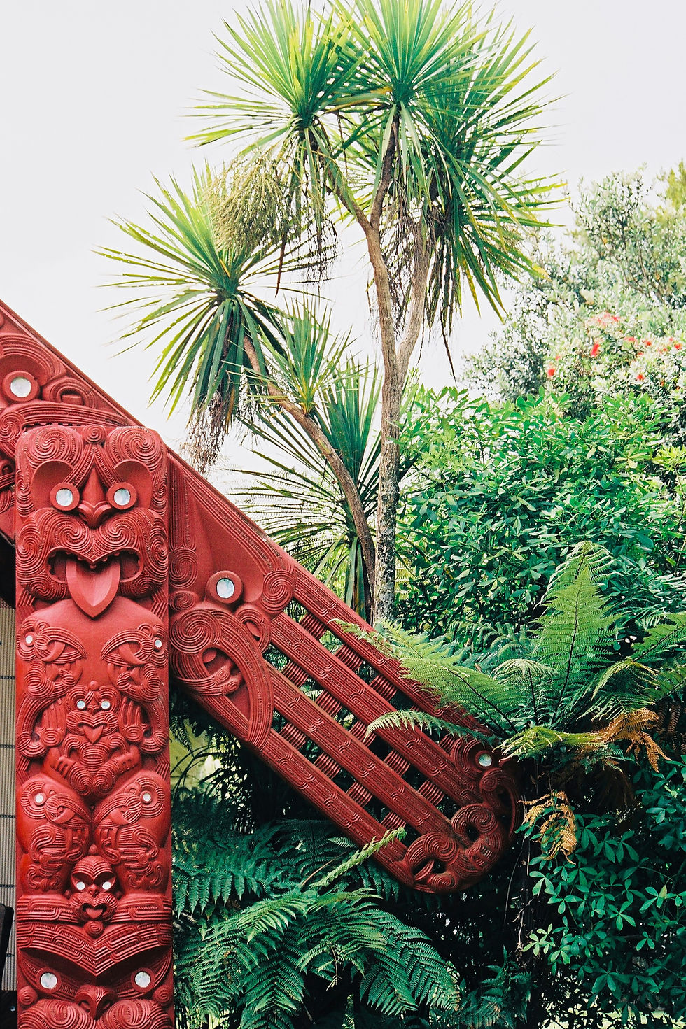 Māori carving on a meeting house, symbolising ancestral presence, spiritual protection, and sacred boundaries in wairua practice.
