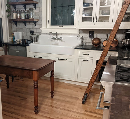 Antique farmhouse sink, walnut table and library ladder are antiques sourced by Denver Squared