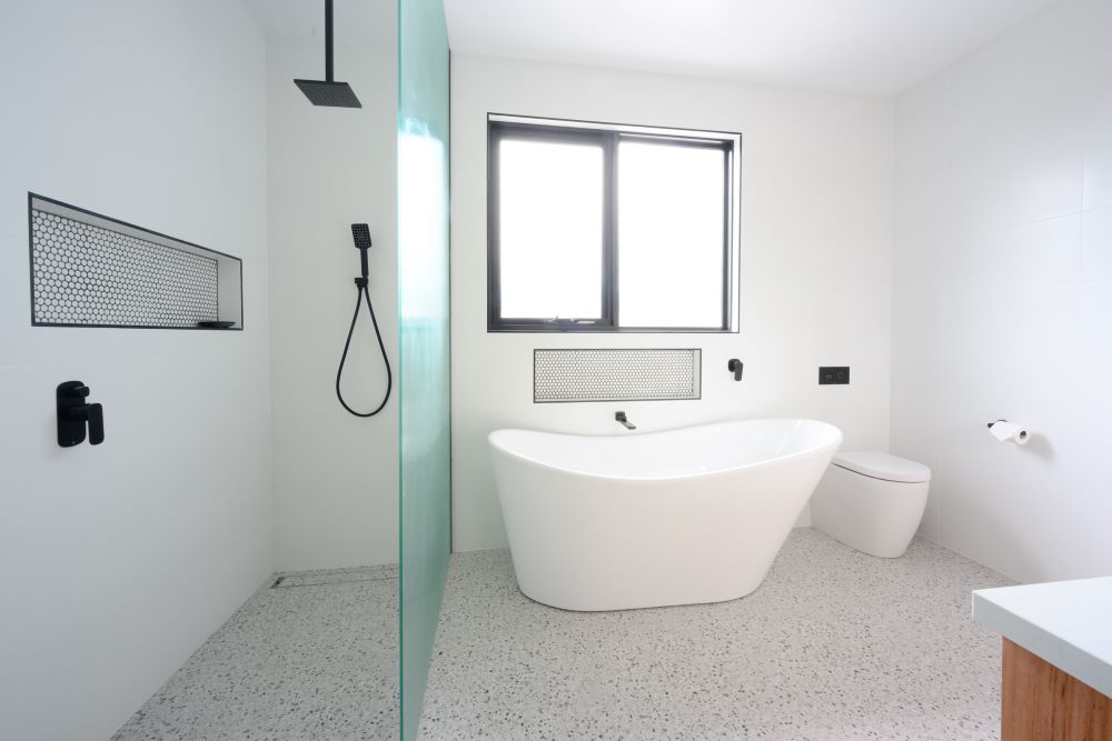 White bathroom with black tapware in a new custom home built by Roberts Builders in Port Campbell