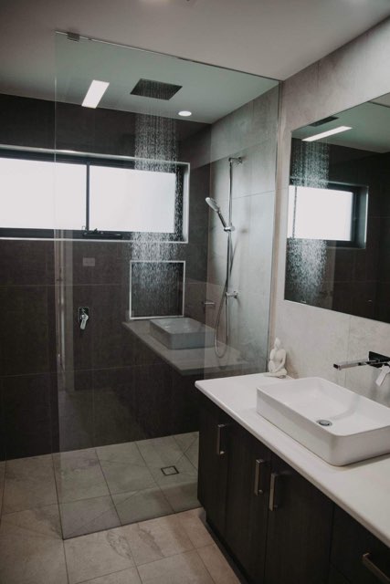 Bathroom with rain shower in new home built by Roberts Builders in Peterborough, Victoria.