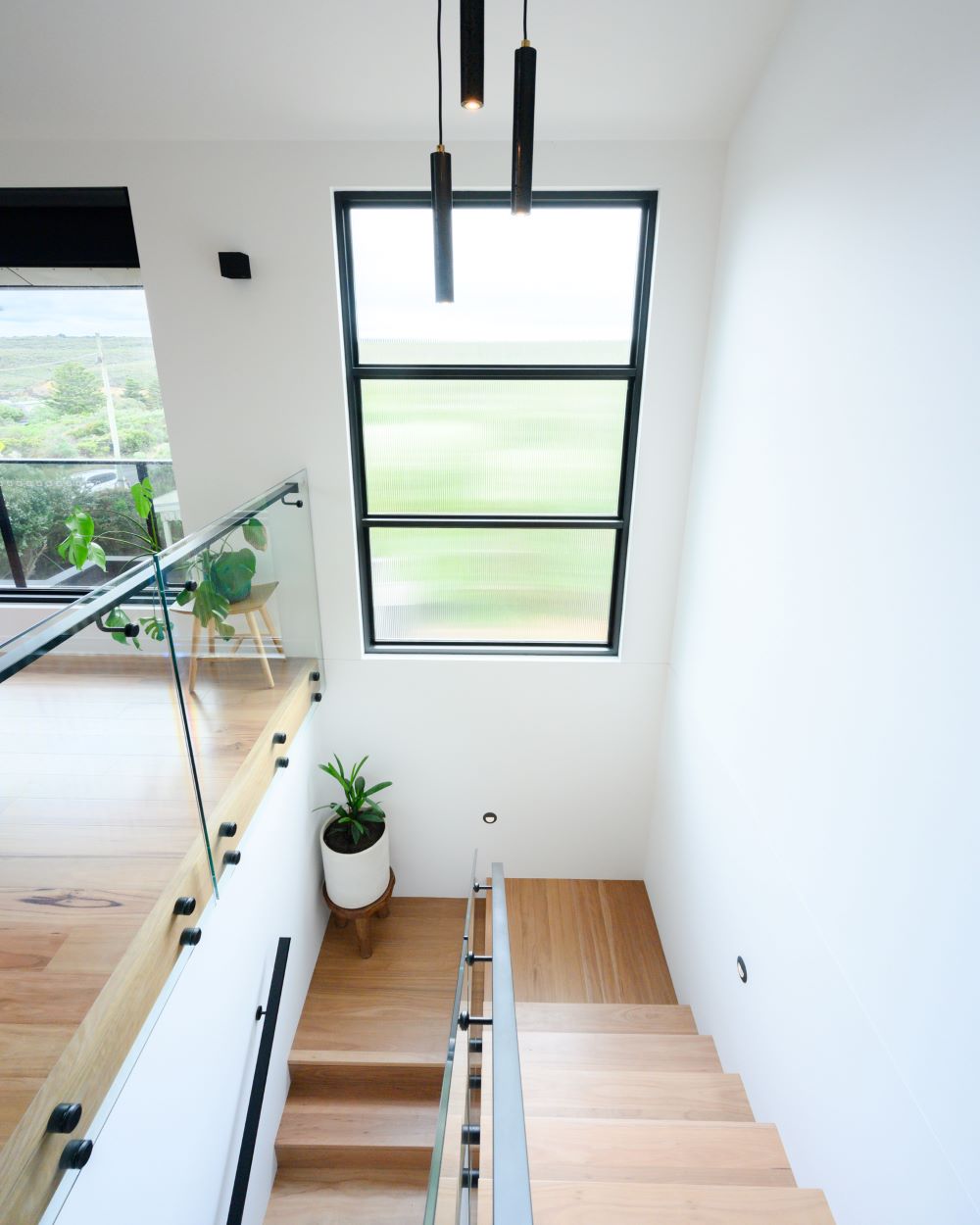Open timber staircase in a new custom home built by Roberts Builders