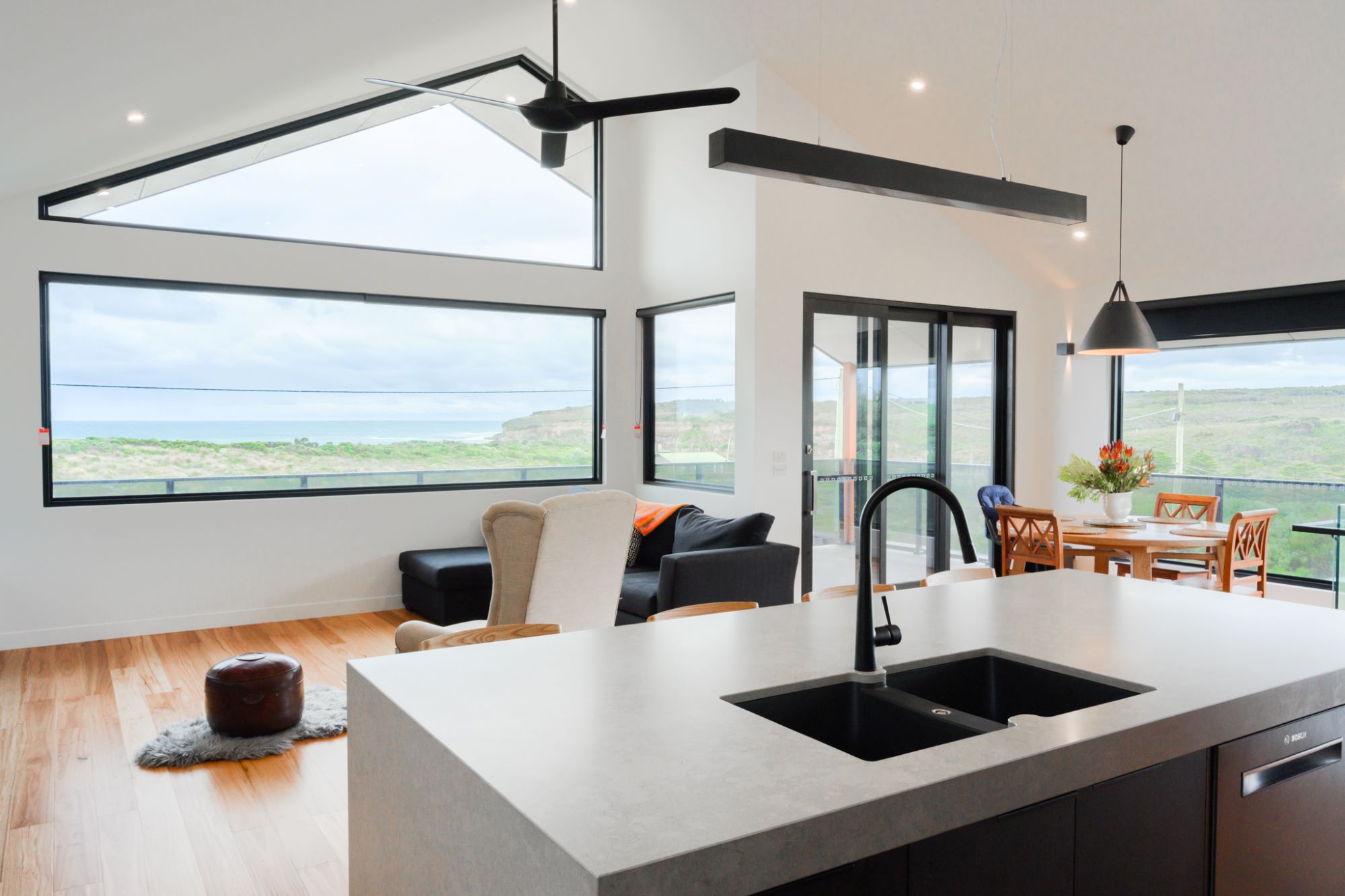 New kitchen, living and dining room with views over the ocean in a home built by Roberts Builders in Port Campbell