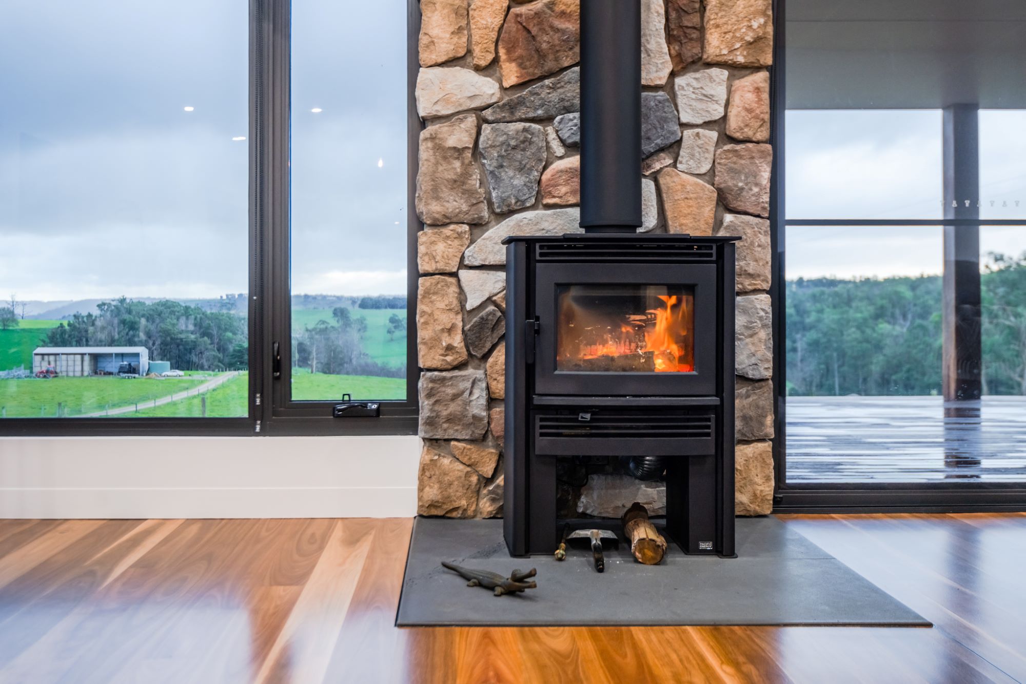 Fireplace and country views from inside a new home in Glenfyne, Victoria built by Roberts Builders Pty Ltd.