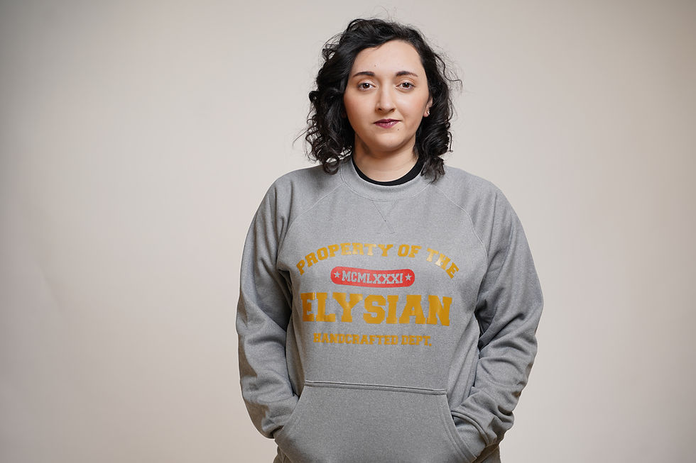 Thumbnail: This is our  Elysian Property of Crewneck in Grey with a gold  Elysian logo on Model.