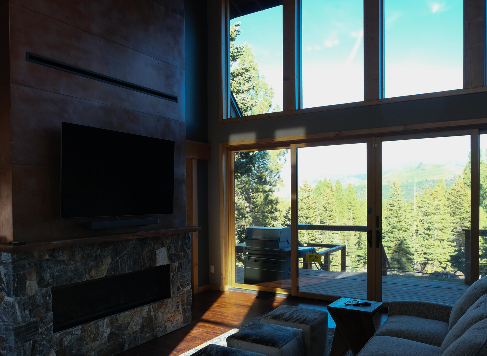 Fireplace and outside view of our mountain contemporary addition residential design for in Juniper Hills Truckee CA, designed by the Architect Alternative MASTRIDICASA