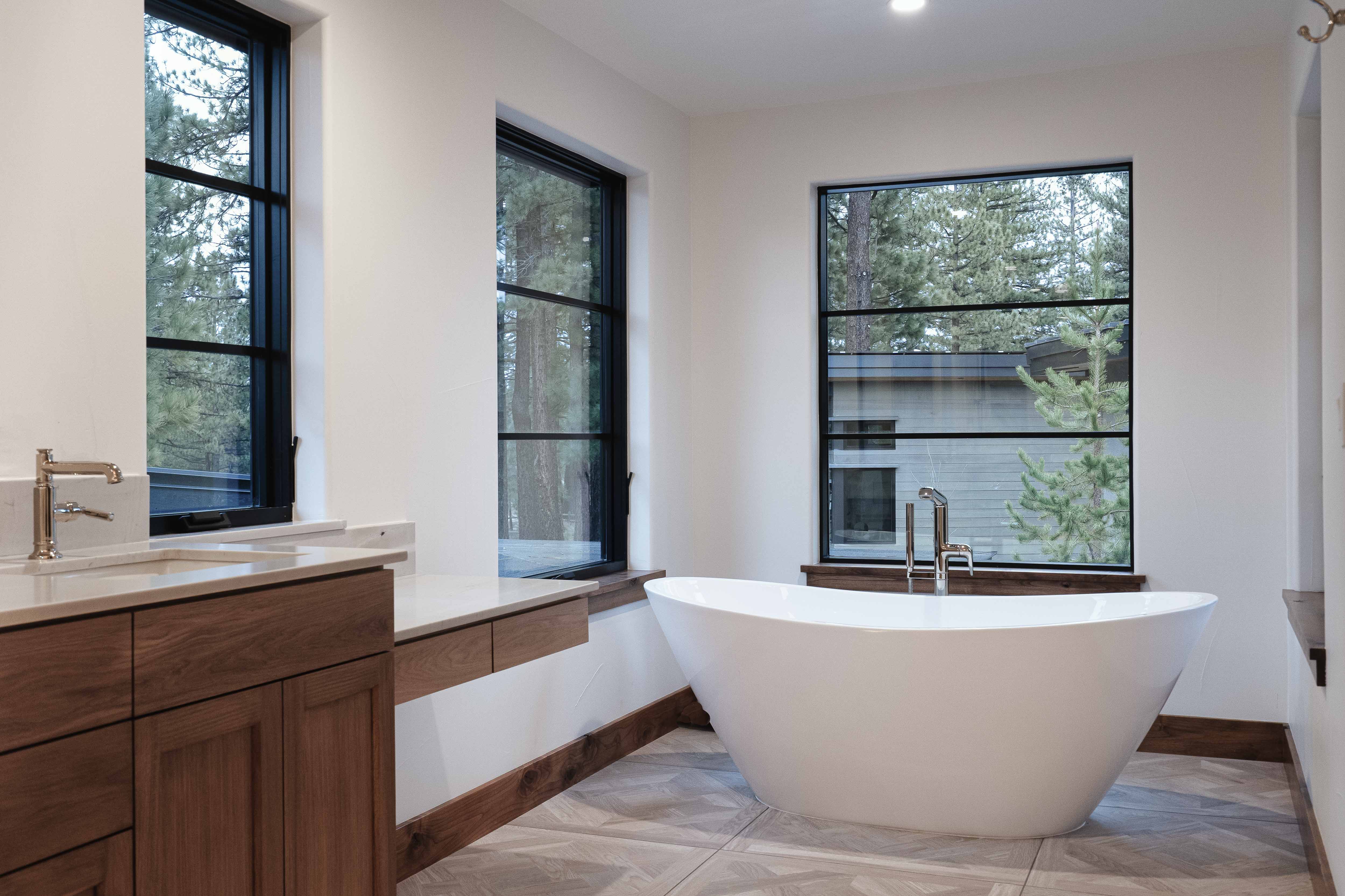 Master bath view with a freestanding bathtub of our modern farmhouse residential design for in Gray's Crossing Truckee CA, designed by the Architect Alternative MASTRIDICASA