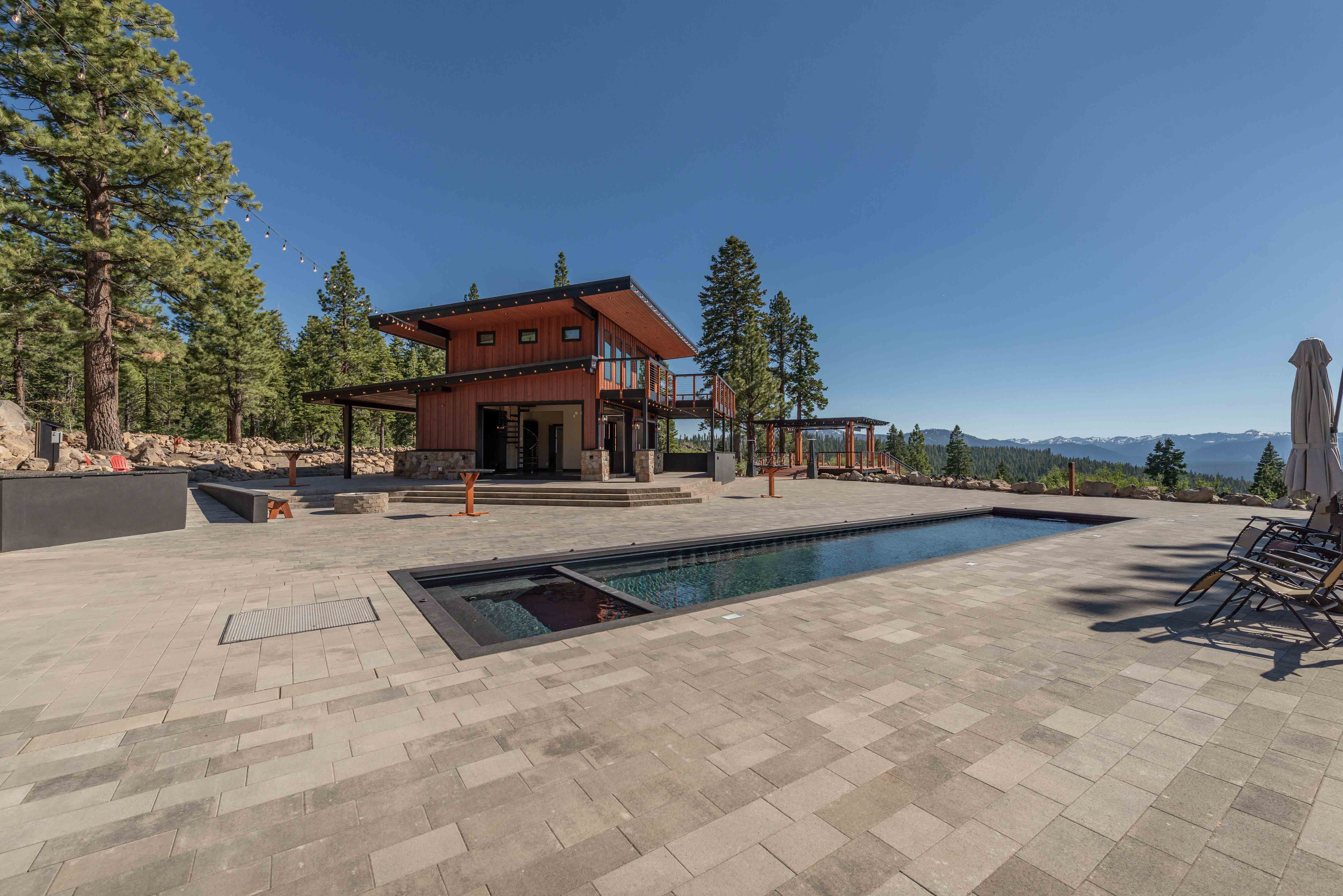Approach view of our mountain modern pool house residential design for in Martis Peak Estates Truckee CA, designed by the Architect Alternative MASTRIDICASA