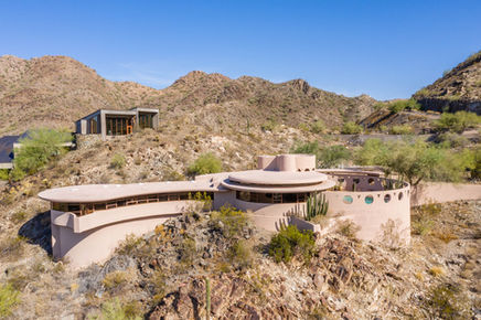 Residential design principle inspired by Frank Lloyd Wright emphasizing site-specific custom home design, hillside homes, Tahoe–Truckee mountain design, slope, views, sun, snow, and homes that belong to the land.
