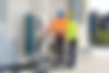Two-Electricians-Men-Wearing-Safety-Jackets-Checking-Air-Conditioning-Unit-On-Building-Roo