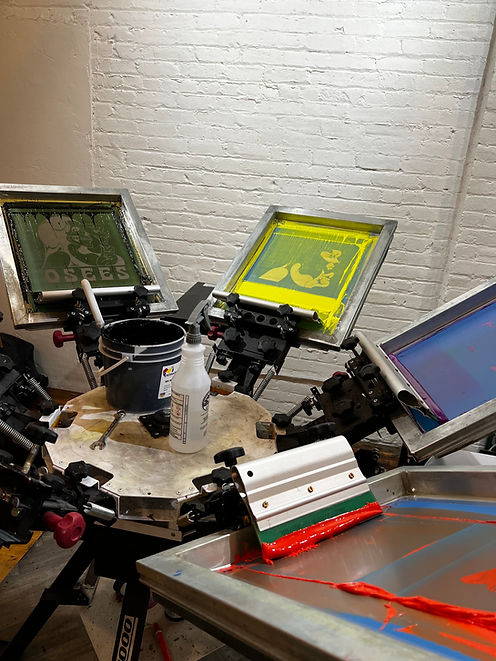 Manual screen printing press in our Gastown Vancouver studio, ready to print small-batch custom t-shirts.