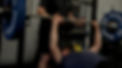 Athlete Bench pressing with spotter