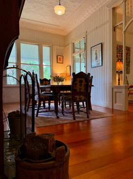 Dining room with pressed metal ceilings, stunning arch ways and a fire place.