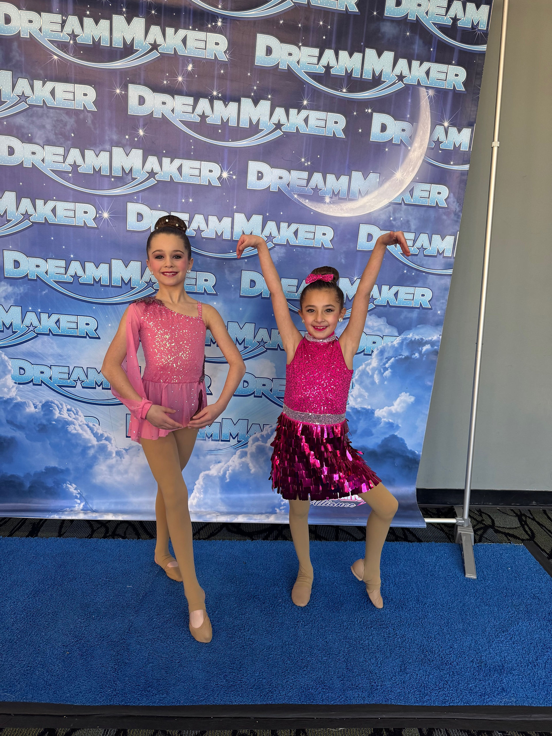 Two young dancers pose DREAM MAKER.