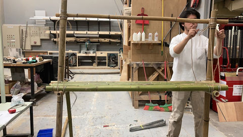 Bamboo shelving for the living room, assembled using jute rope and wire binding.
