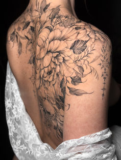 botanical back piece tattoo with ornaments