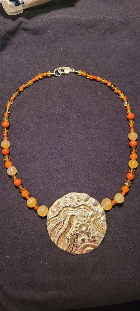 Venue18_Judi Rowlands_chasing and repousse pendant.jpg