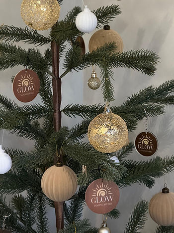 A Christmas Tree with Glow Tanning Studio Llanelli Baubles and Gift Tags