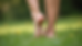 Close-up view of a pair of feet standing on a soft natural surface