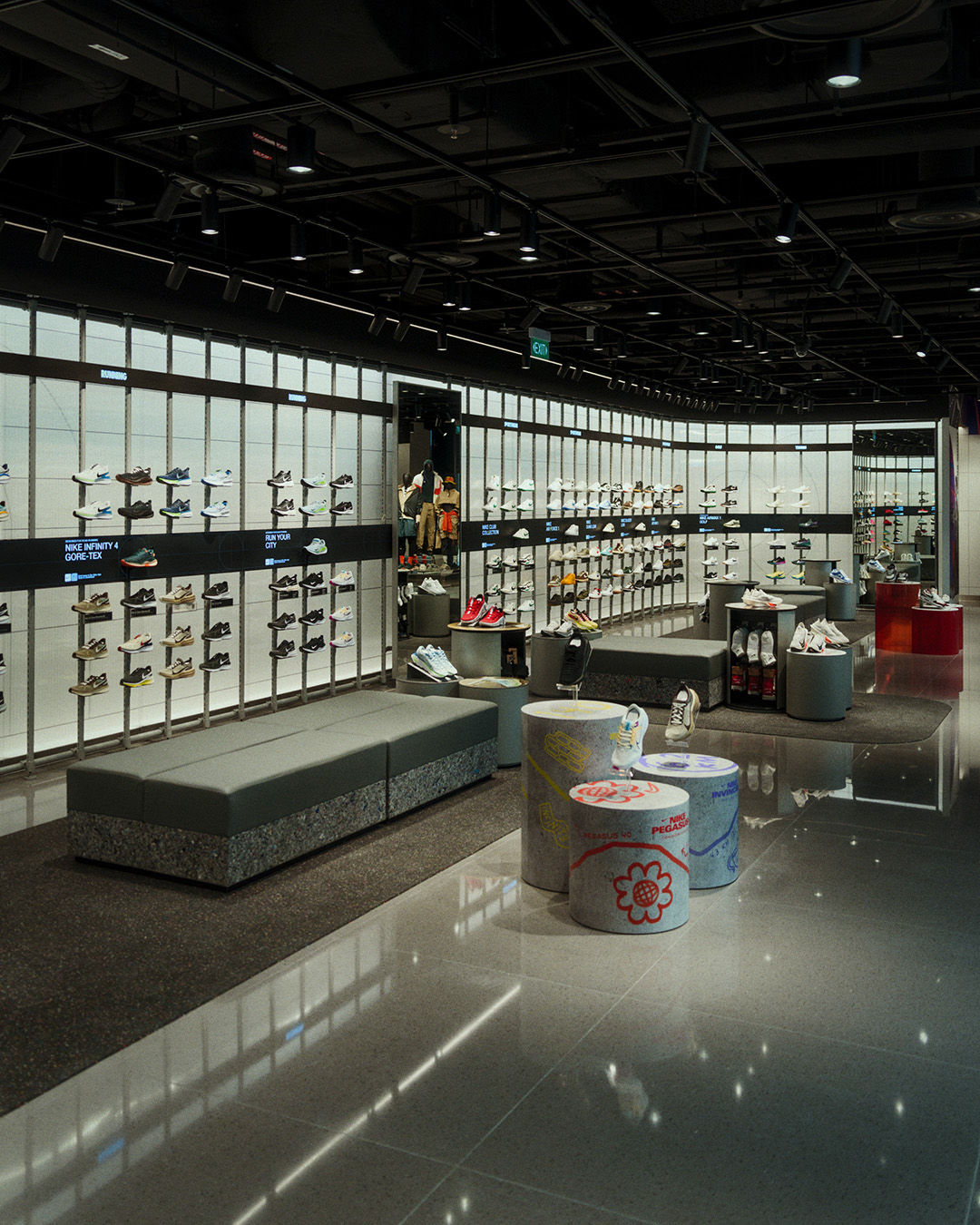 inside empty NIKE orchard store with couches and wall mounted sneaker display