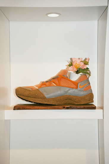 wall mounted display with shoe as plant pot in atmos sendagaya tokyo shibuya