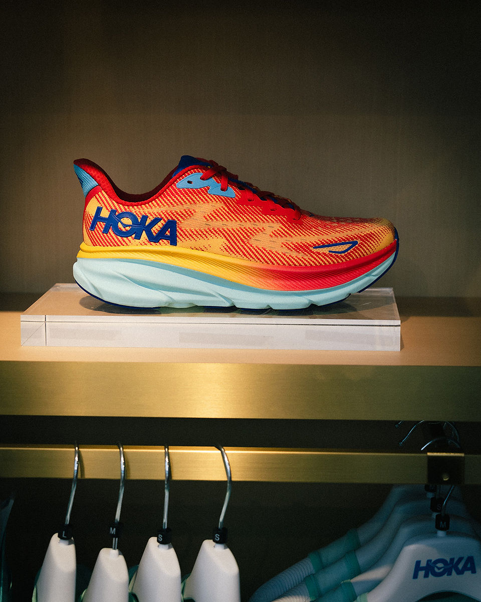 colorful JOKA running shoe in elevated hovering display in red, yellow and orange color