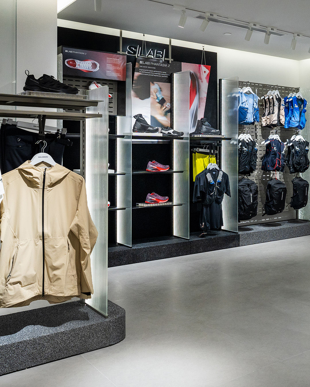 Inside of Salomon store in raffles city singapore showing display racks of apparel and shoes