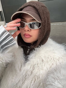 Photo of Nursena  ina  brown hoodie, furry coat, brown hat and a nude colour sunglasses