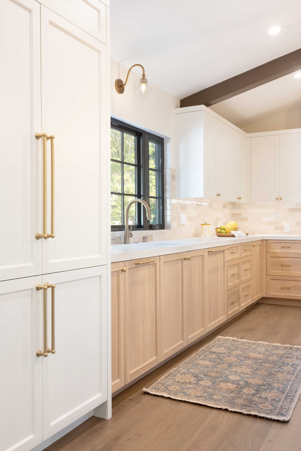 traditional kitchen remodel white cabinets rift cut white oak cabinets marble countertops large kitchen eat in kitchen vaulted ceiling brass lighting wood beams