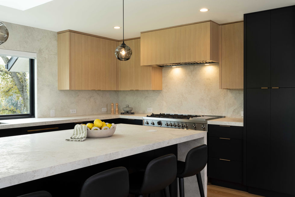 black and rift cut white oak kitchen. large waterfall island. black cabinets