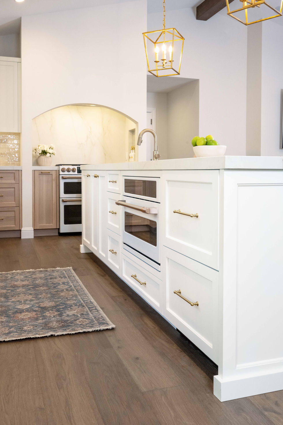 traditional kitchen remodel white cabinets rift cut white oak cabinets marble countertops large kitchen eat in kitchen vaulted ceiling brass lighting wood beams