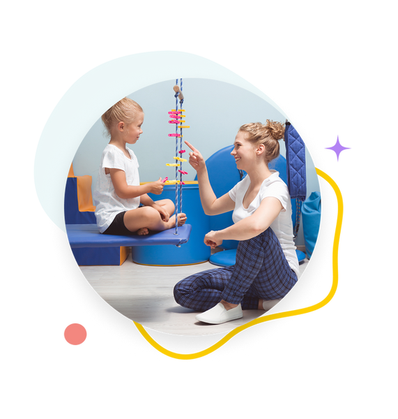Therapist and young girl playing with colorful sensory toy during therapy session
