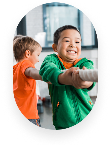 Children playing tug of war indoors
