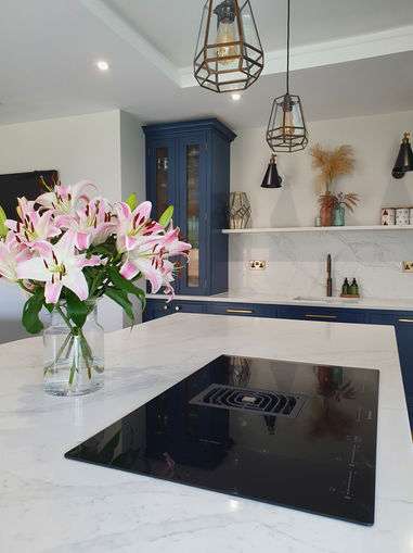Matthew Kirk Interiors bespoke, handmade inframe kitchen kitchen in Harrogate, North Yorkshire. Painted in Fired Earth Carbon Blue with appliances from Quooker and Neff and Calacatta gold quartz worksurfaces.