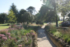 Drifts of perennial planting in raised beds along the gravel path leading to the Blackburn Wing