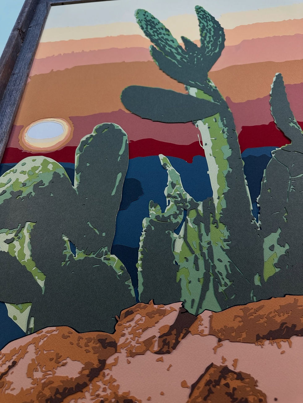 a painting of cactus with a sunset in the background
