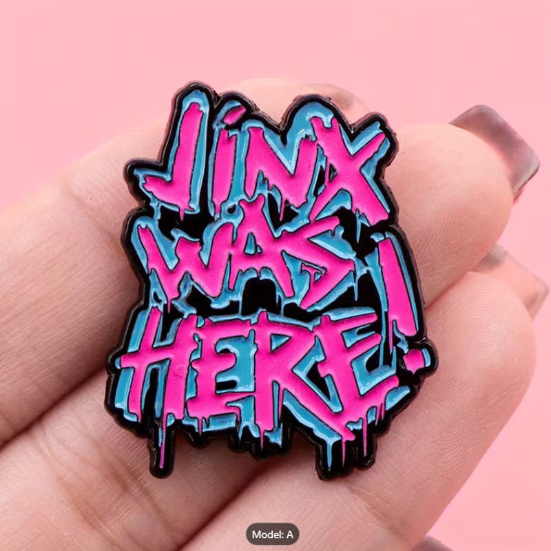 Thumbnail: pink and blue Jinx Was Here enamel pin