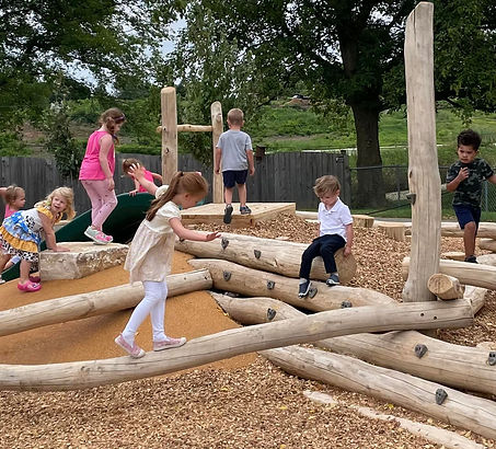 exploring the natural climbing equipment on our nature playground at messiah lutheran Preschool and kindergarten