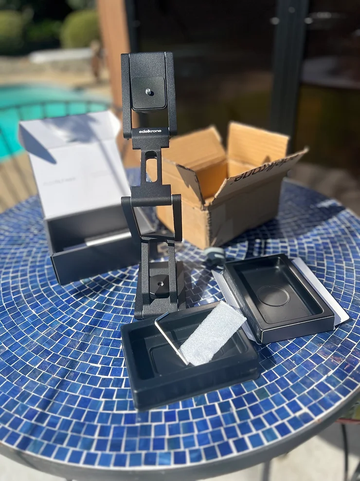 The FlexTilt MAX model unpacked on a table with packaging in the background.