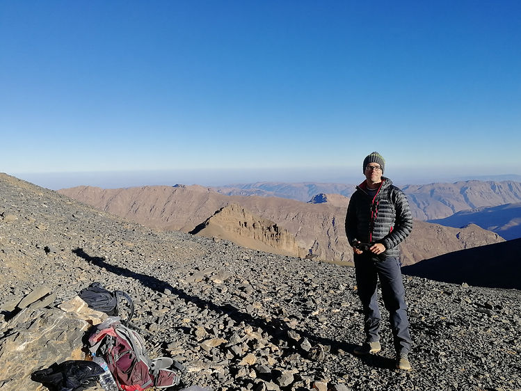 Adrian Ferraro standing on Mt Mgoun summit ridge in Morocco