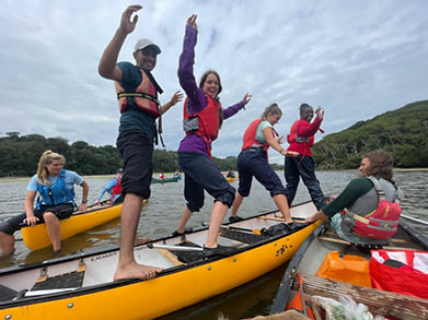 A group of young people playing games in canoes