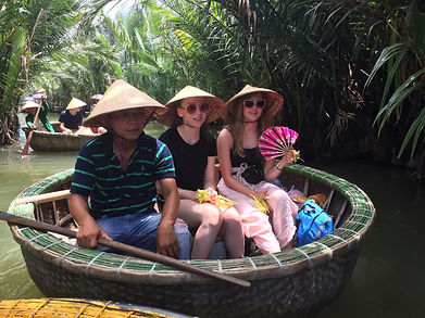 tourists in a traditional boat in Vietnam